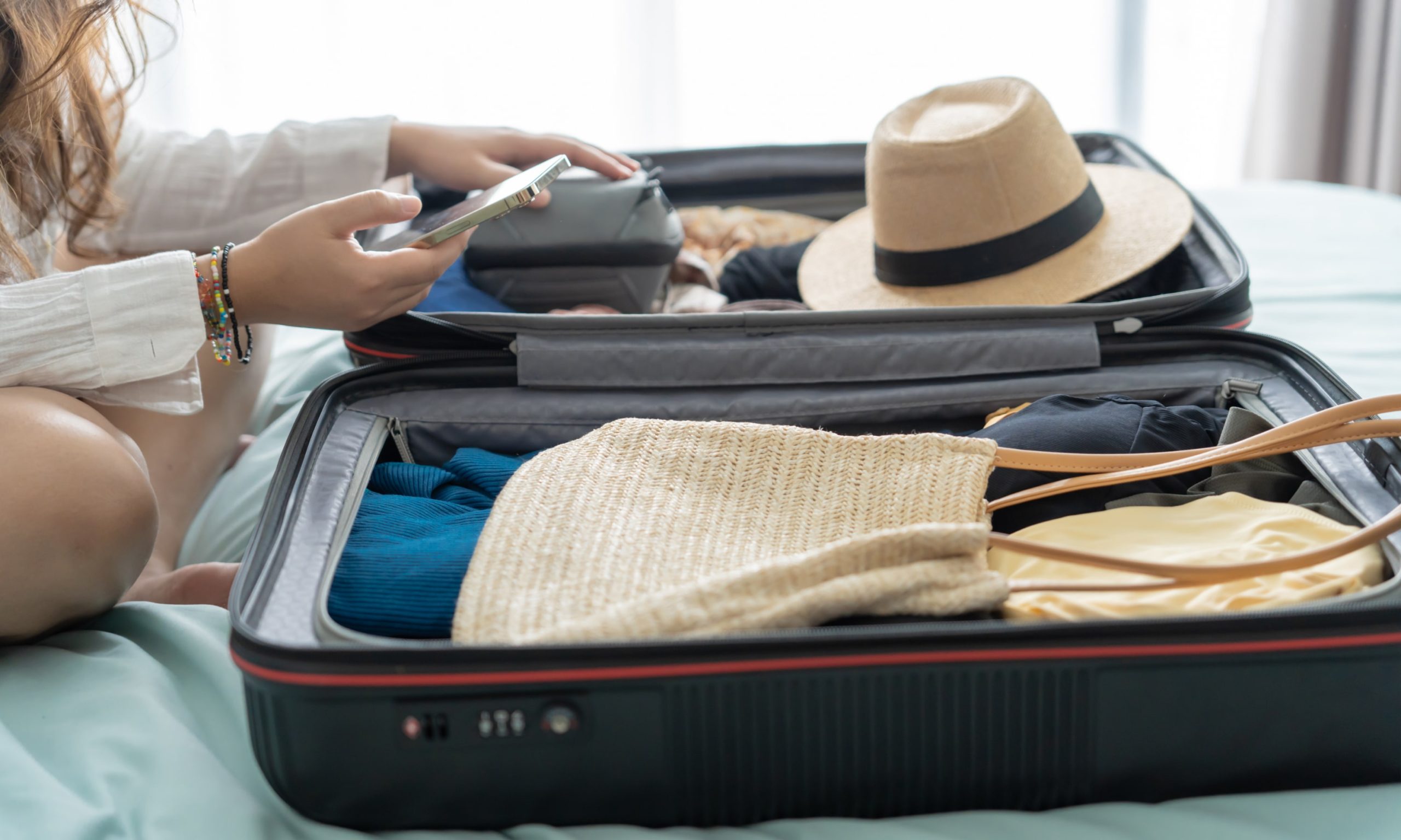 Person packing their luggage for traveling