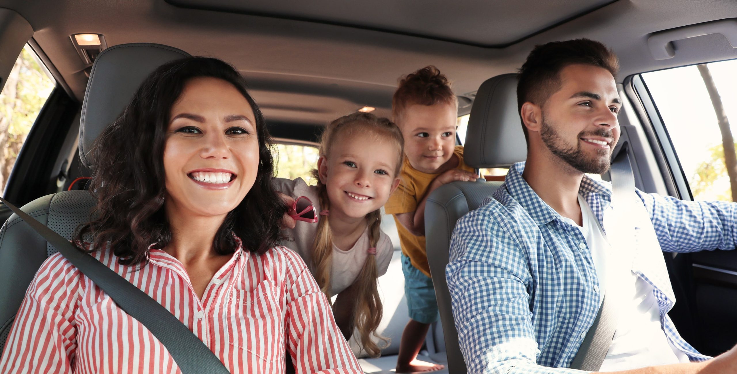 Family inside a car they are renting