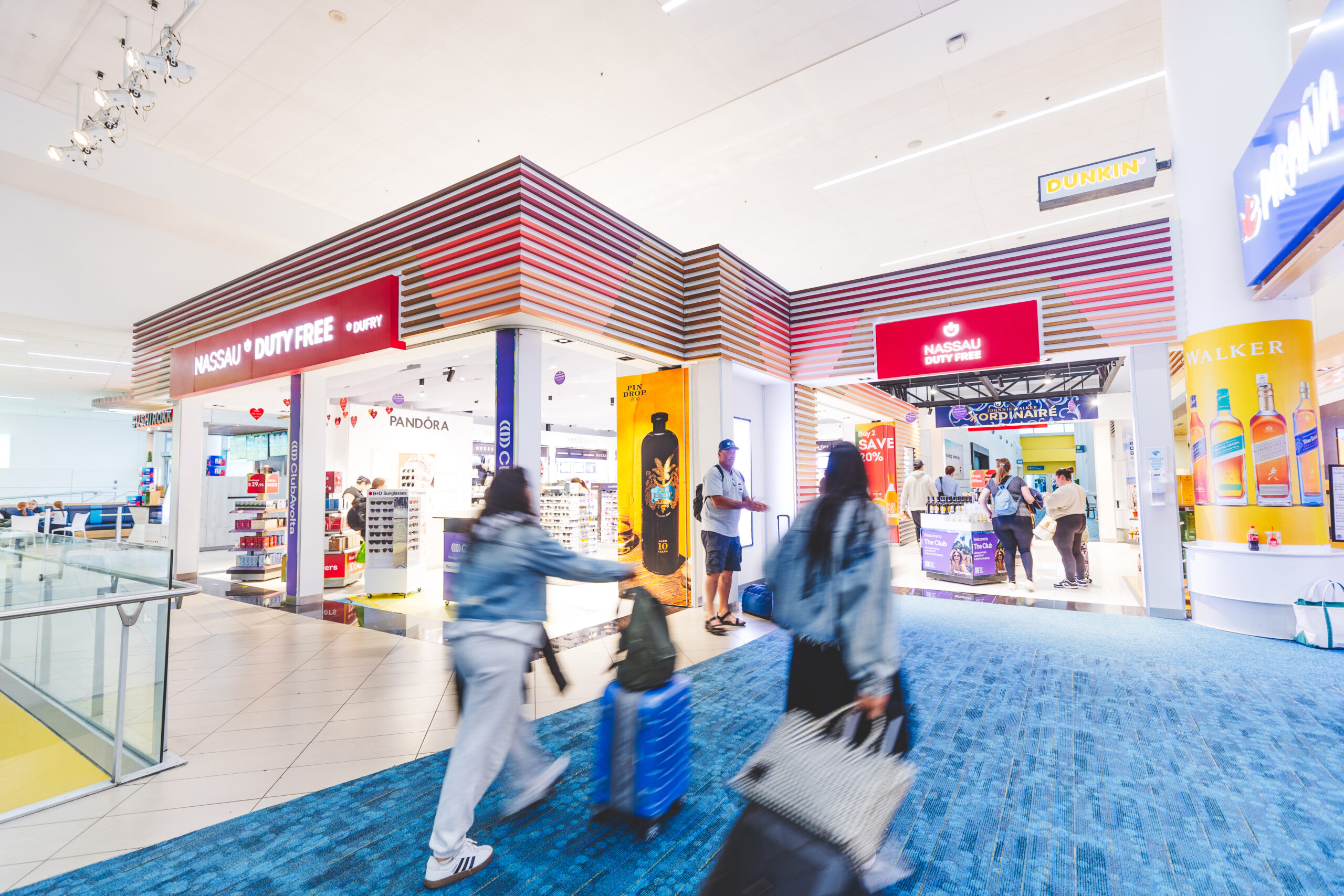 Travellers walking through the interior of the airport.