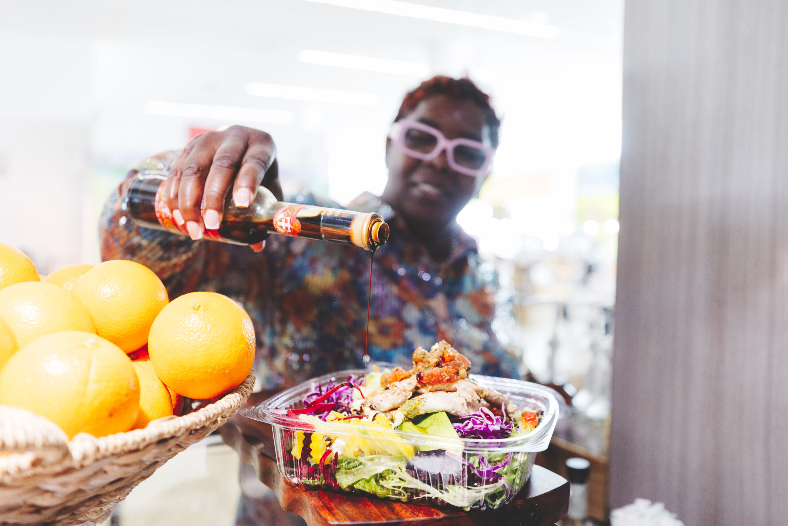 Chef adding sauce to a meal.